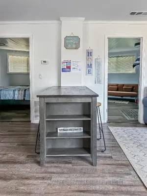 a gray table in a room with a bedroom at Peaceful Lydia Hide-O-Way - New Pool & Near Beach, Breakfast, Spa & Go-Karts! in Panama City Beach