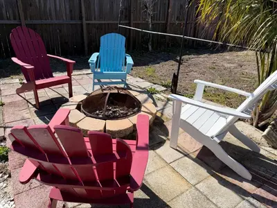 three chairs and a fire pit in a yard at Peaceful Lydia Hide-O-Way - New Pool & Near Beach, Breakfast, Spa & Go-Karts! in Panama City Beach