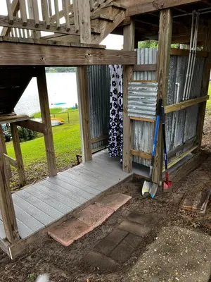 an outside view of a wooden house with a door at The Fifth Promise - A Cozy Lakehouse Retreat in Chipley