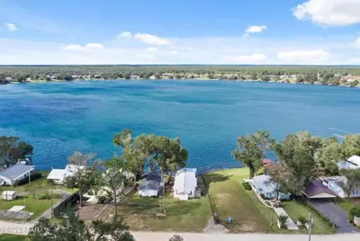 an aerial view of a lake with houses and trees at The Fifth Promise - A Cozy Lakehouse Retreat in Chipley