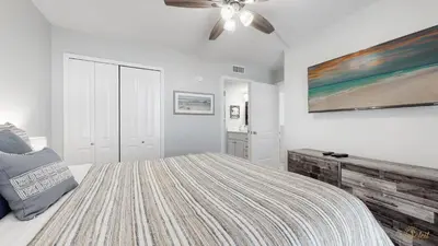 a bedroom with a bed and a ceiling fan at Beachfront - Renovated - Gulf view Bedroom - FLPCB5 in Panama City Beach