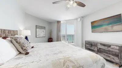 a bedroom with a bed and a ceiling fan at Beachfront - Renovated - Gulf view Bedroom - FLPCB5 in Panama City Beach