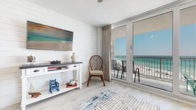 a living room with a view of the ocean at Beachfront - Renovated - Gulf view Bedroom - FLPCB5 in Panama City Beach