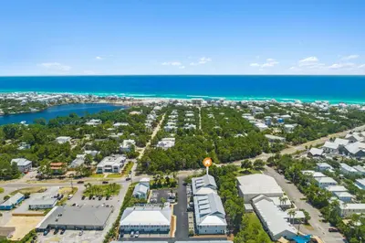 an aerial view of a parking lot next to the ocean at 30A Townhomes at Seagrove by Panhandle Getaways in Santa Rosa Beach