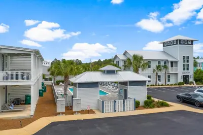 aominium building with a pool and a parking lot at 30A Townhomes at Seagrove by Panhandle Getaways in Santa Rosa Beach