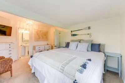 a bedroom with a large white bed and a chair at Panama City Home with Beach Gear and 2 Bikes in Panama City