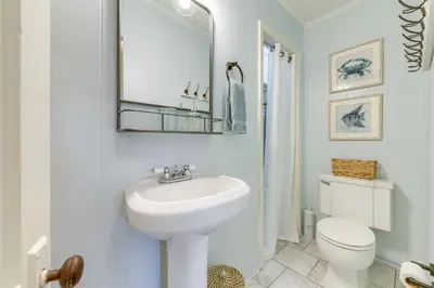 a white bathroom with a sink and a toilet at Panama City Home with Beach Gear and 2 Bikes in Panama City