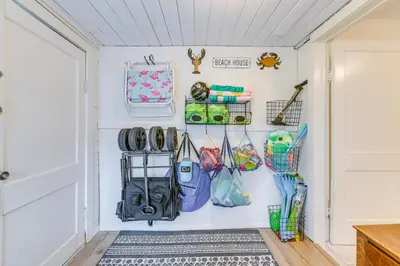 a hallway with purses and bags hanging on a wall at Panama City Home with Beach Gear and 2 Bikes in Panama City