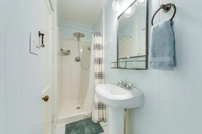 a white bathroom with a sink and a shower at Panama City Home with Beach Gear and 2 Bikes in Panama City