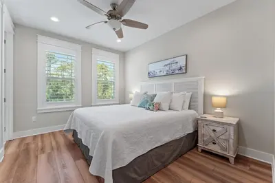 a bedroom with a bed and a ceiling fan at Hidden Tides in Rosemary Beach