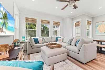 a living room with a couch and a table at Hidden Tides in Rosemary Beach