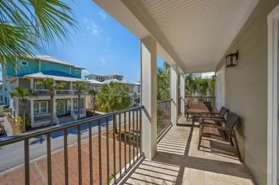 a balcony with a view of a house at Seacrest Getaway in Rosemary Beach