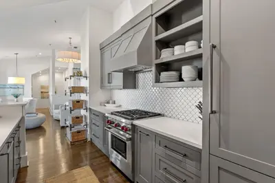 a kitchen with white cabinets and a stove at The Savannah Unit 2E in Rosemary Beach