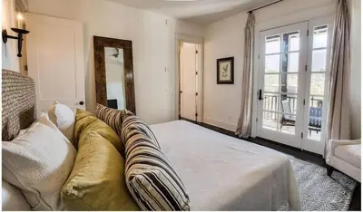 a living room with a couch and a window at Dejarnette Cottage in Rosemary Beach