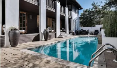 a swimming pool in the middle of a house at Dejarnette Cottage in Rosemary Beach