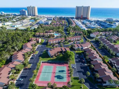 an aerial view of a resort with a tennis court at Portside Resort Pet Friendly Rentals by Panhandle Getaways in Panama City Beach