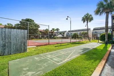a basketball court in a park with palm trees at Portside Resort Pet Friendly Rentals by Panhandle Getaways in Panama City Beach