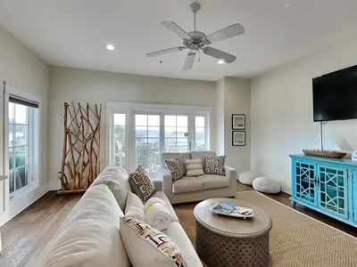 a living room with a couch and a tv at Eastern Lake Village #E - Just 4 Fun in Seagrove Beach