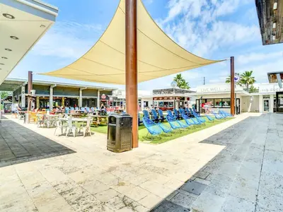 a large canopy over a patio with chairs and tables at Eastern Lake Village #E - Just 4 Fun in Seagrove Beach