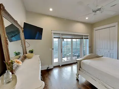 a bedroom with a bed and a mirror and a tv at Eastern Lake Village #E - Just 4 Fun in Seagrove Beach