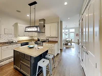 a kitchen with white cabinets and a island with a counter top at Eastern Lake Village #E - Just 4 Fun in Seagrove Beach