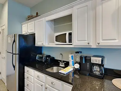 a kitchen with white cabinets and a sink and a microwave at Inn at Seacrest #203 - 30A Get-A-Way in Rosemary Beach