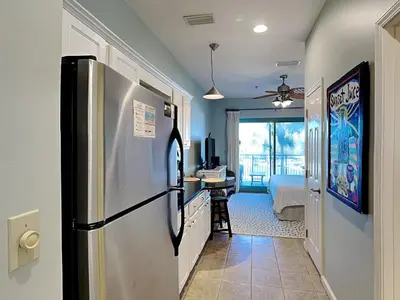a kitchen with a refrigerator and a bedroom at Inn at Seacrest #203 - 30A Get-A-Way in Rosemary Beach