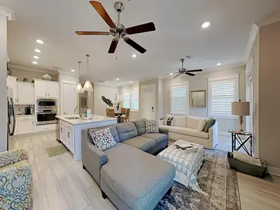 a living room with a couch and a ceiling fan at Prominence North #94A - Happy Ours in Watersound Beach
