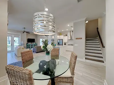 a dining room with a glass table and chairs at Prominence North #94A - Happy Ours in Watersound Beach