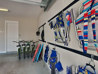 a room with a bunch of surfboards hanging on a wall at Prominence North #94A - Happy Ours in Watersound Beach