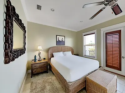 a bedroom with a white bed and a window at Seabreeze Cabana in Rosemary Beach