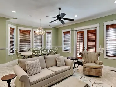 a living room with a couch and a dining room at Seabreeze Cabana in Rosemary Beach