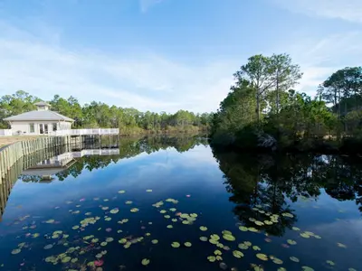 a body of water with a house in the background at Seagrove Highlands #2104 in Santa Rosa Beach