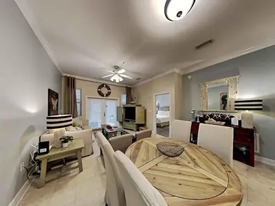 a dining room and living room with a table and chairs at Seagrove Highlands #2104 in Santa Rosa Beach