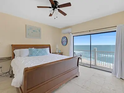 a bedroom with a bed and a large window at Seagrove Dunes #1 in Seagrove Beach