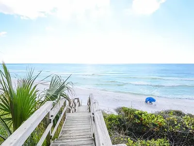 a wooden staircase leading to a beach with the ocean at Seagrove Dunes #1 in Seagrove Beach