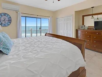 a bedroom with a bed and a view of the ocean at Seagrove Dunes #1 in Seagrove Beach