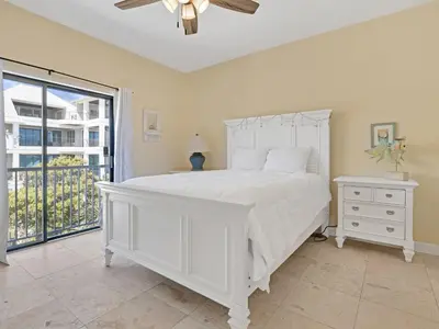 a bedroom with a white bed and a window at Seagrove Dunes #1 in Seagrove Beach