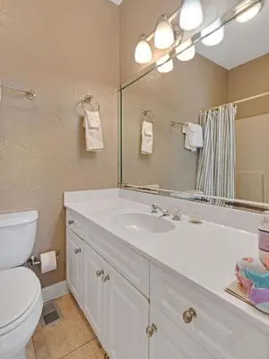 a bathroom with a sink and a toilet and a mirror at Seagrove Dunes #1 in Seagrove Beach