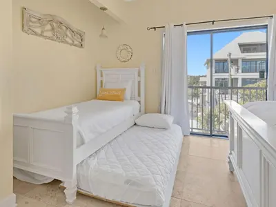 a bedroom with two beds and a balcony at Seagrove Dunes #1 in Seagrove Beach