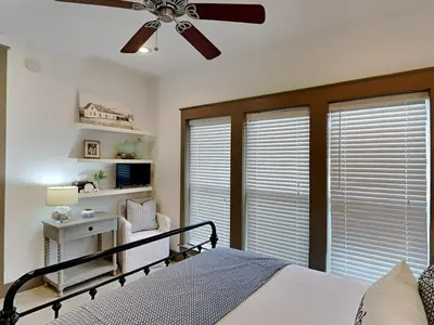 a bedroom with a bed and a ceiling fan at The Holland House II in Rosemary Beach