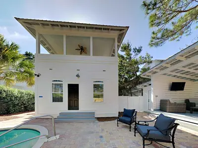 a white house with a spider on the roof at Happy as a Clam in Santa Rosa Beach