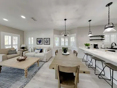 a large living room with a table and a kitchen at Happy as a Clam in Santa Rosa Beach