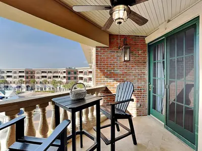 a patio with a table and chairs on a balcony at Village Of South Walton #403E in Rosemary Beach