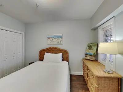 a bedroom with a bed and a lamp and a window at Village Of South Walton #403E in Rosemary Beach