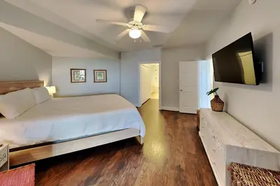 a bedroom with a bed and a flat screen tv at Village Of South Walton #403E in Rosemary Beach