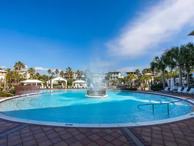 a large swimming pool with a fountain in the middle at Casa Migos in Rosemary Beach