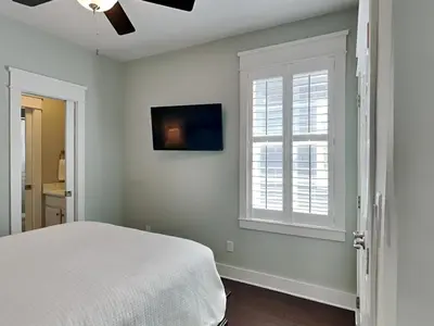 a bedroom with a bed and a window at Casa Migos in Rosemary Beach
