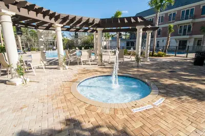 a swimming pool with a fountain in a patio at Village Of South Walton #263A in Rosemary Beach