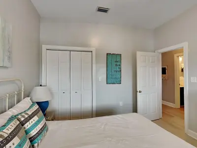 a white bedroom with a bed and a lamp at Village Of South Walton #263A in Rosemary Beach